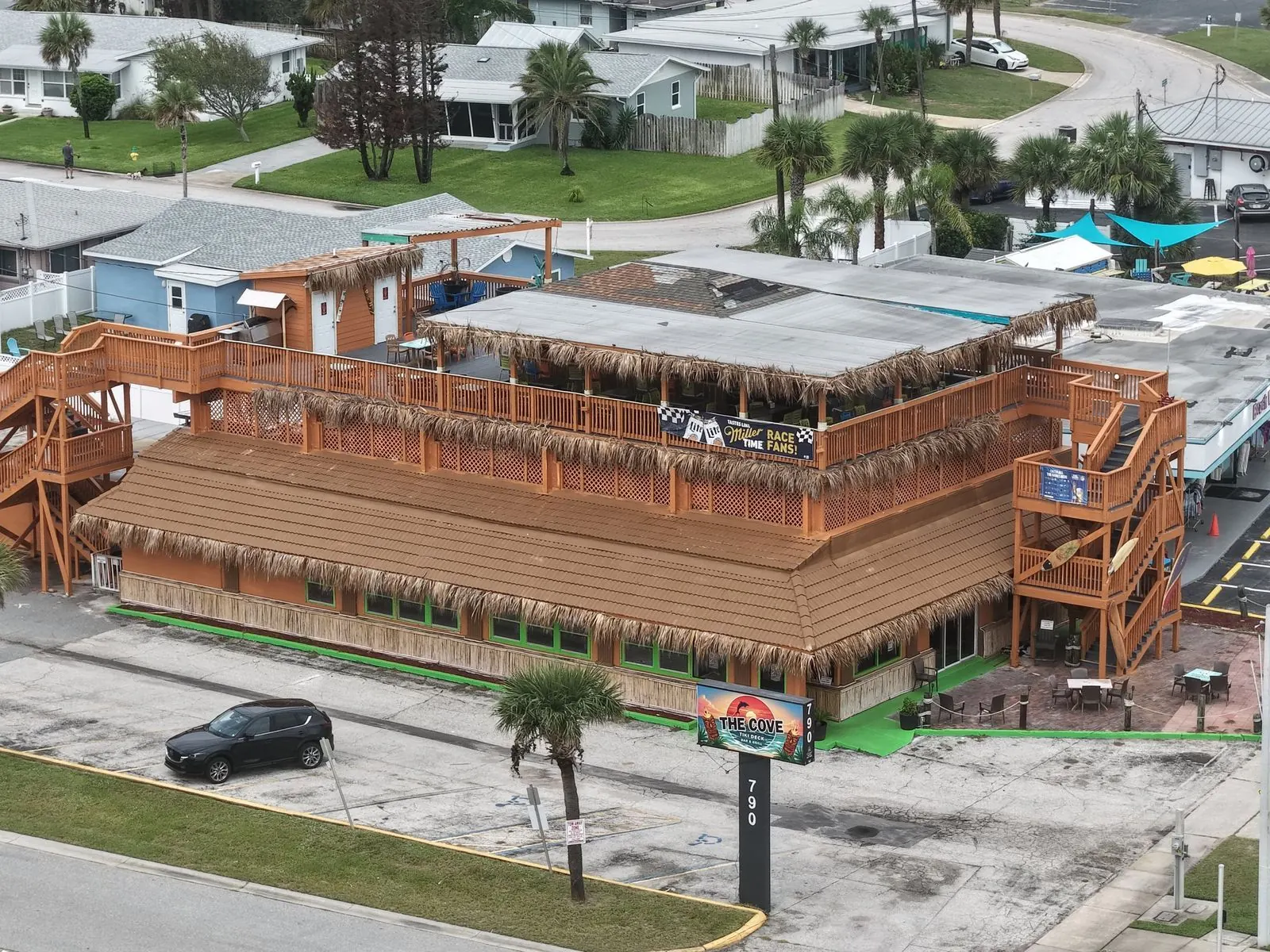 Aerial photo of a rooftop tiki deck at a beachside restaurant